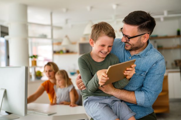 Father and child using digital tablet for e-learning. Education home digital device kid concept.