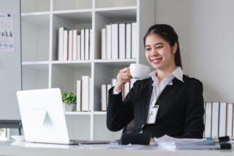 Successful Asian businesswoman sitting in modern office Use your laptop to manage your work